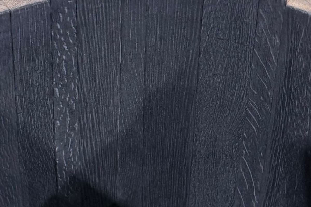 Blackened oak surface with visible wood grain and minimal visible cracking