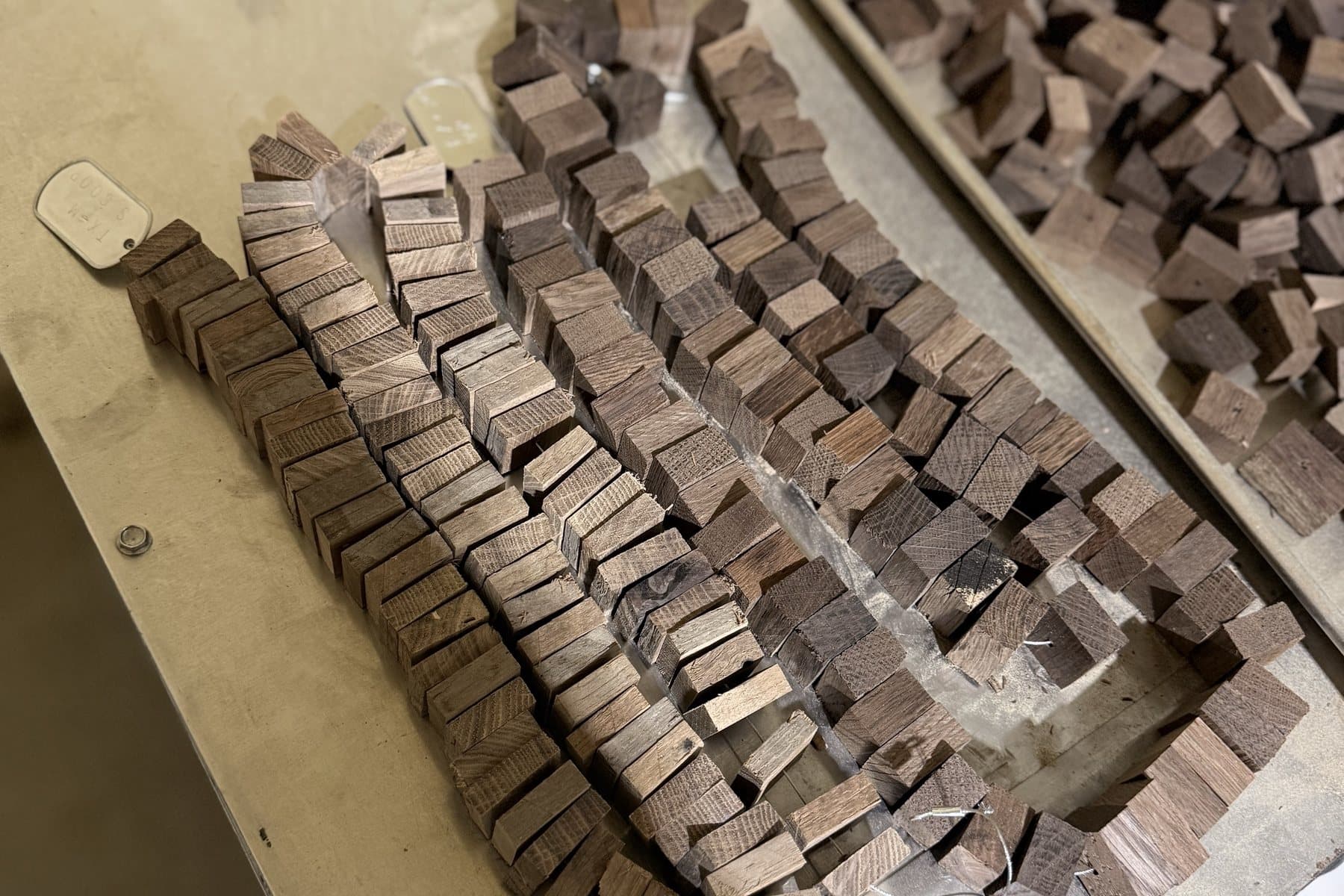 Oak insert cubes assembled on stainless steel cables at Standard Cooperage
